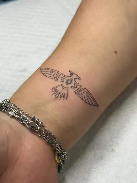 A thunderbird in fine line on the wrist.